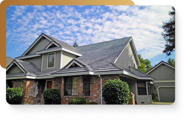 A red brick suburban home featuring grey roofing in austin, texas
