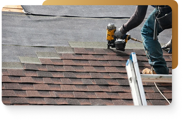 Roofing contractors using a nail gun to attach brown asphalt shingles to the roof of a home in Lakeway, Texas