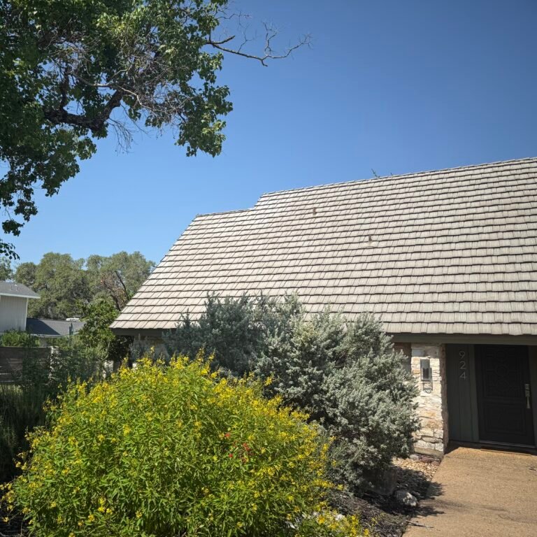 Front facade of a custom Lakeway home with shingle-style metal roof lasting more than 50 years.