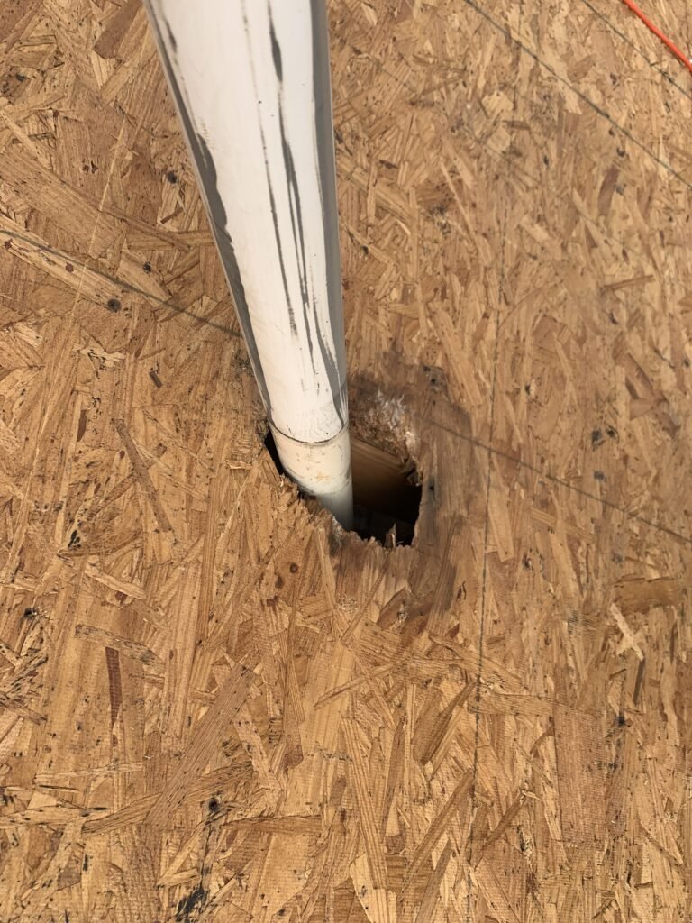 Vent stack showing gap in the decking board before a boot is installed.