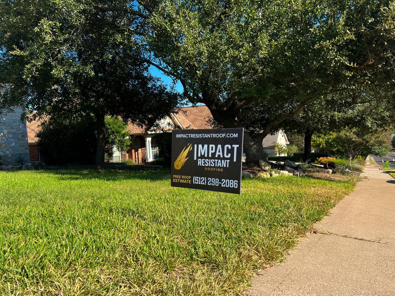 Austin roofing company Impact Roofing & Renovation yard sign in Covered Bridge