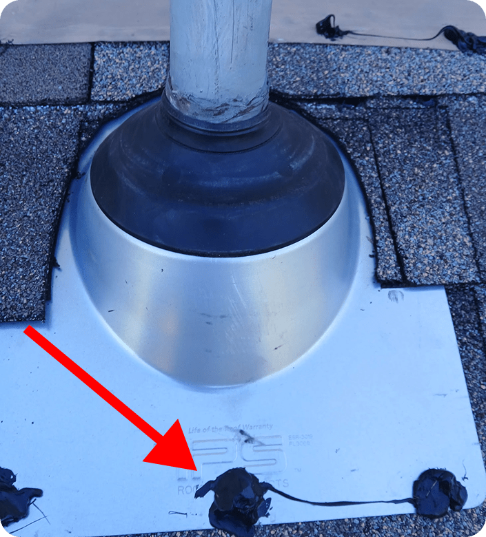 A vent boot flashing with nails sealed using caulk to prevent water leaks.