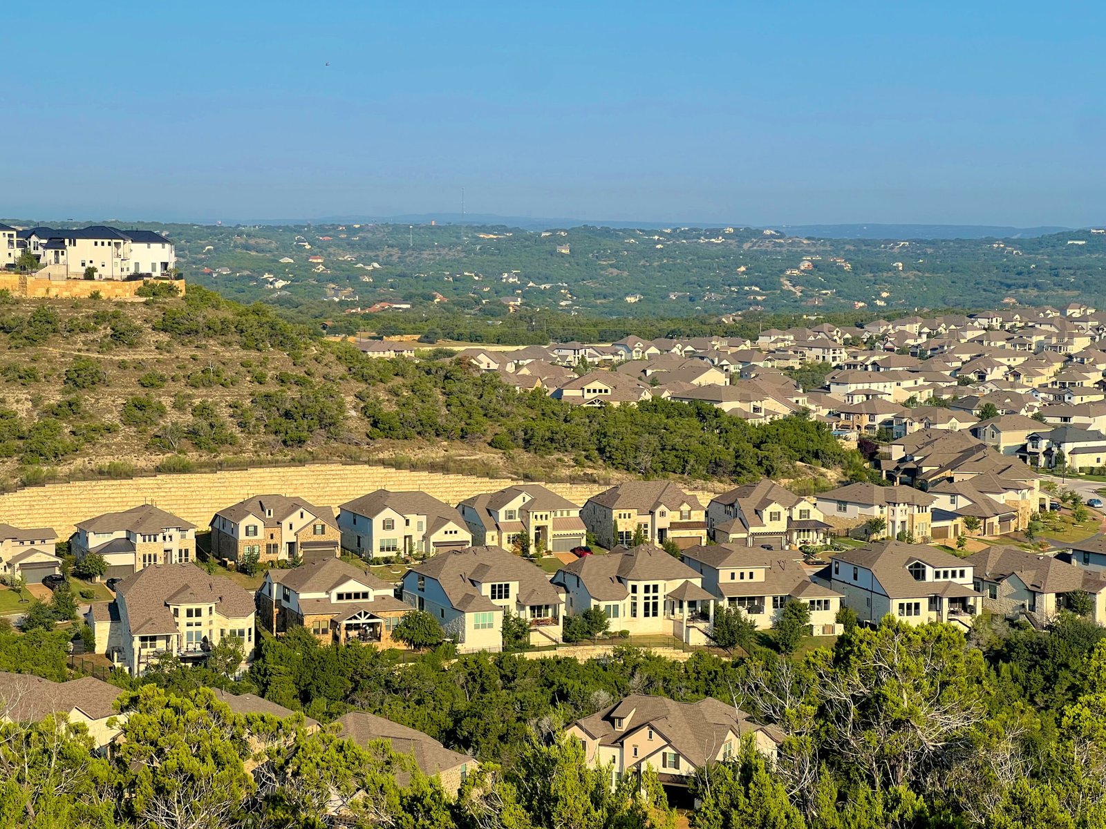 Austin roofing skyline shows homes in Rough Hollow with their newly completed roofs